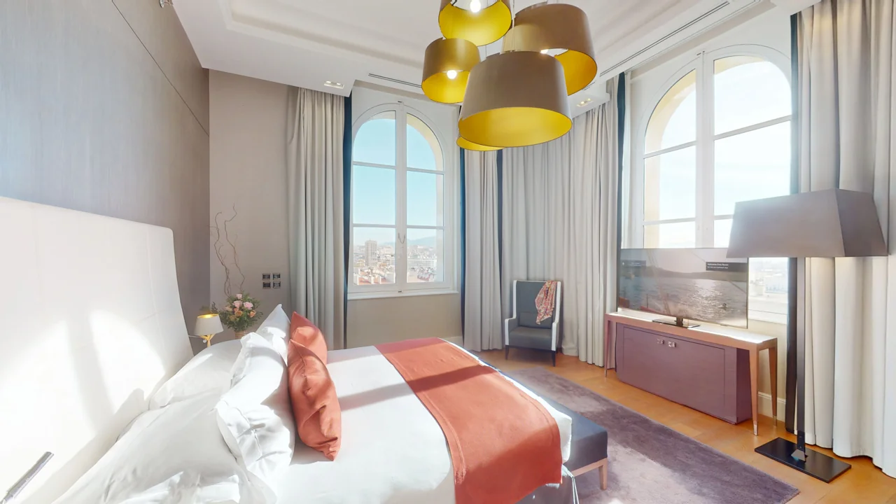 Bright bedroom with bay windows and yellow pendant lights