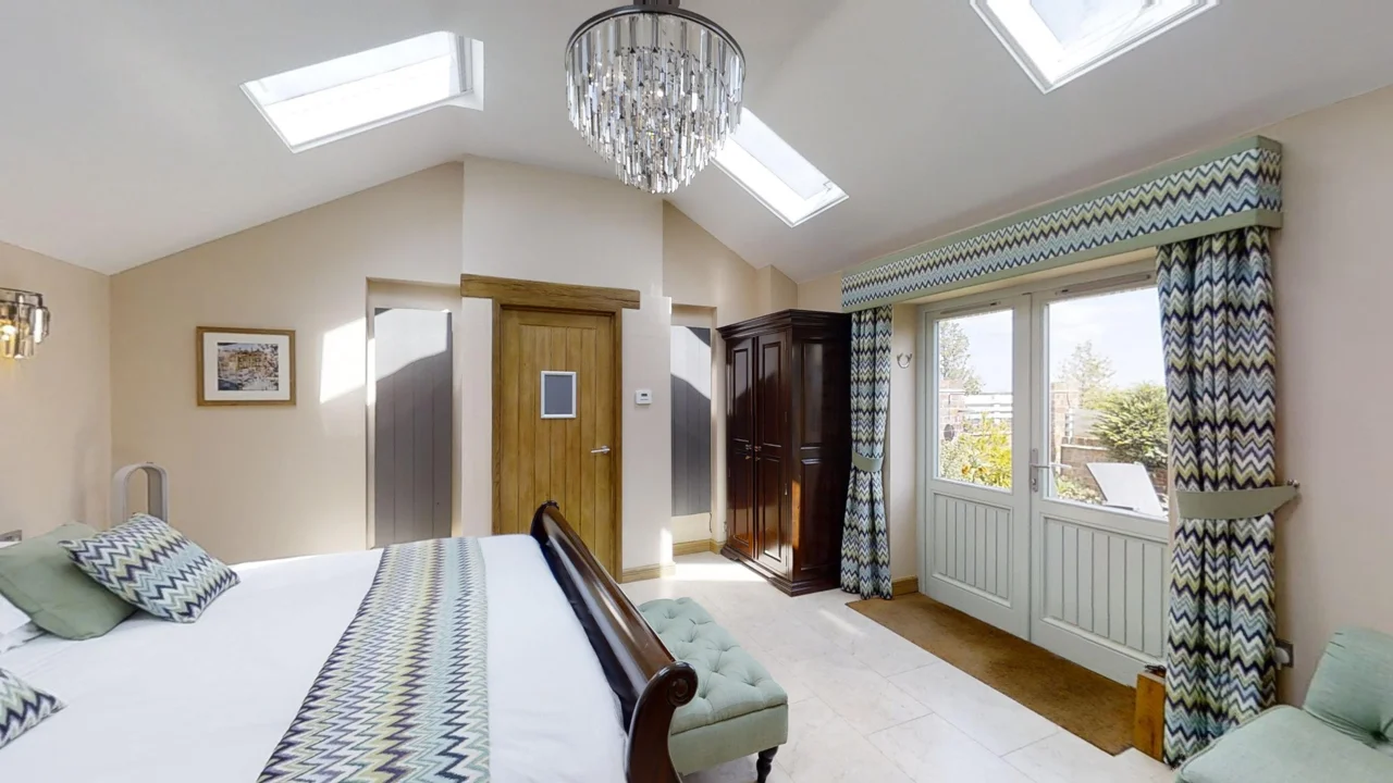 Wide view of a spacious bedroom with skylights
