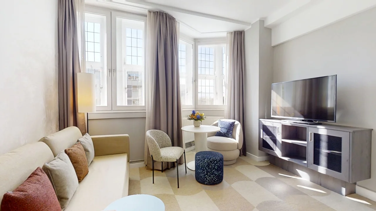 Light-filled living room with seating, large windows and property photography by 3Dtour.site